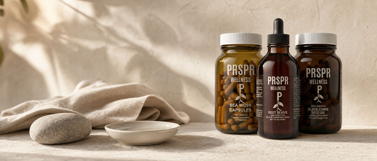 PRSPR Wellness Hair and Skin Stack products arranged on a warm beige plaster surface with a river stone and folded linen