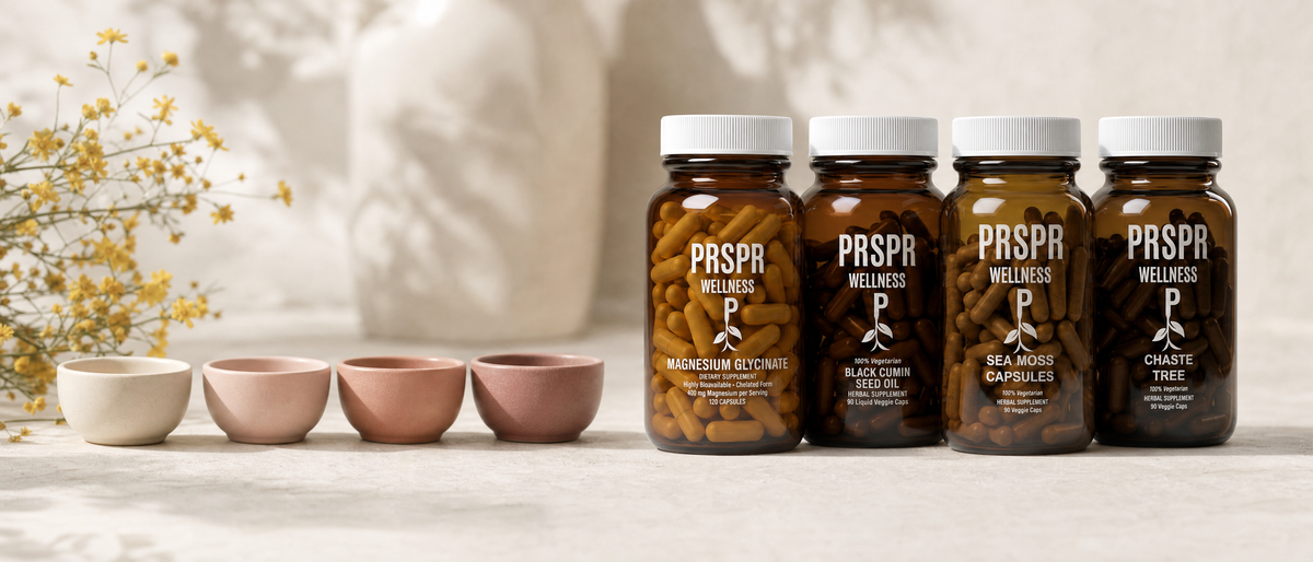PRSPR Women's Essentials bundle jars in a row beside four small pink ceramic bowls and a sprig of yellow flowers