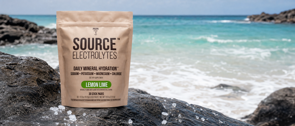 PRSPR Source Electrolytes Lemon Lime pouch on wet rocks at the edge of the sea, where the salinity of seawater starts