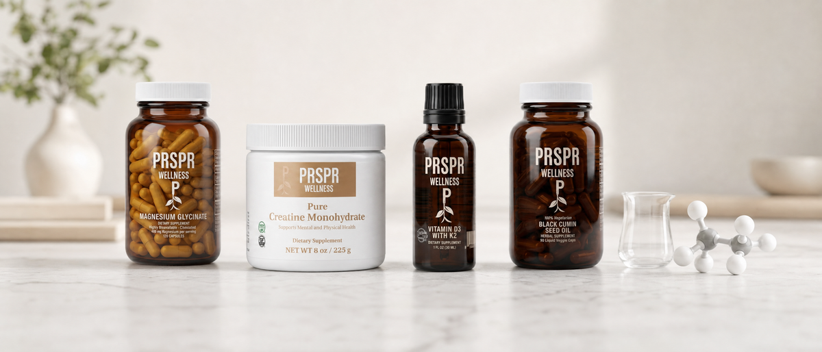 PRSPR Essentials Bundle: Magnesium Glycinate, Pure Creatine Monohydrate, Vitamin D3 with K2 and Black Cumin Seed Oil on a marble counter beside a glass beaker and a ball-and-stick molecular model