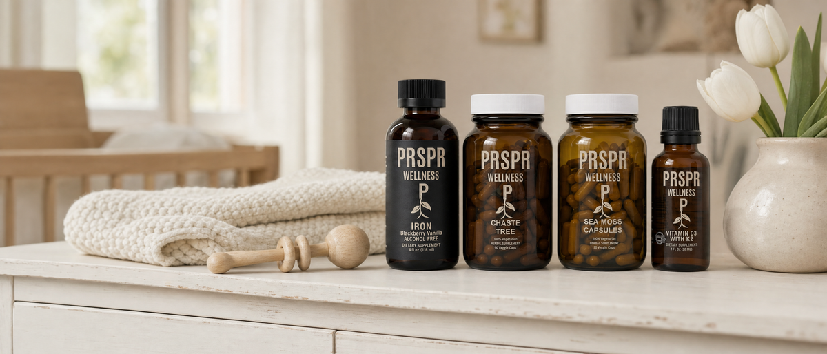 PRSPR Wellness Iron, Chaste Tree, Sea Moss Capsules and Vitamin D3 with K2 on a nursery dresser beside a knitted baby blanket, a wooden rattle and white tulips.