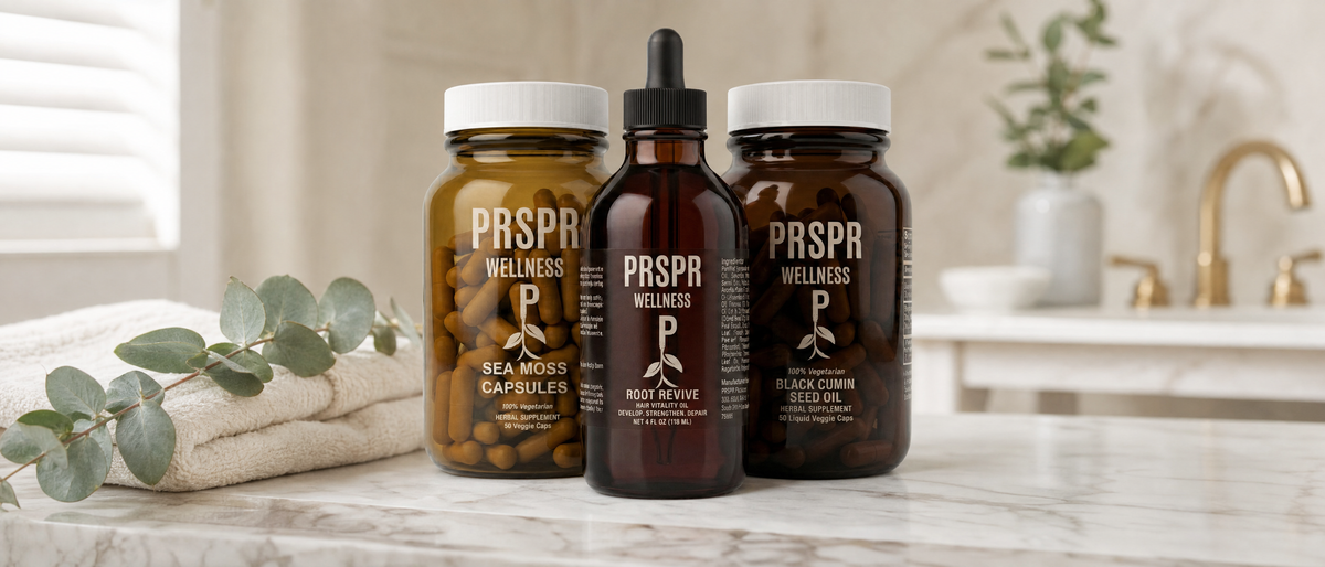 Sea Moss Capsules, Root Revive hair vitality oil and Black Cumin Seed Oil capsules on a marble bathroom vanity