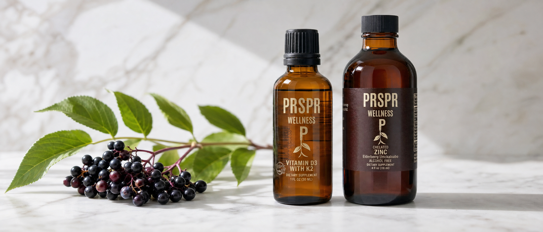 PRSPR Vitamin D3 with K2 dropper and Chelated Zinc with Elderberry bottle on marble beside fresh elderberries