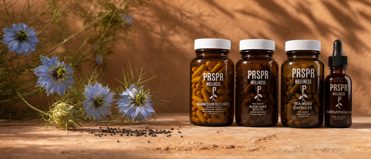 PRSPR Wellness Inflammation Reset Stack on terracotta beside pale blue Nigella sativa flowers, a dried pod and black seeds