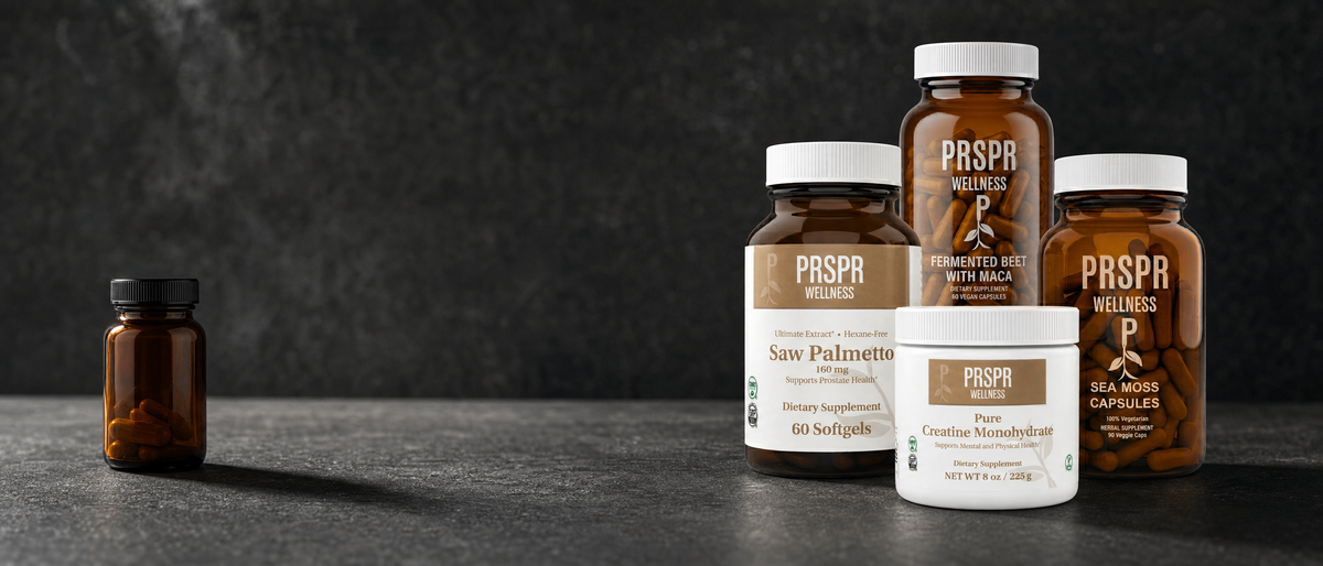 PRSPR Wellness Men's Vitality Stack on dark charcoal concrete beside a single small amber tablet bottle
