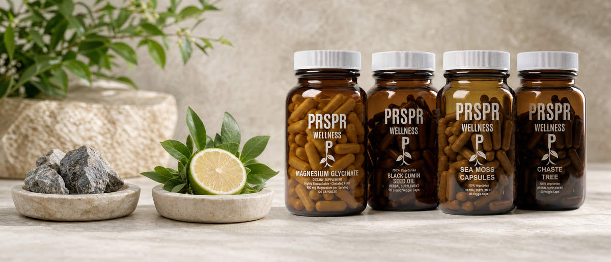 PRSPR Wellness Women's Daily Edge on pale limestone beside two stone dishes holding mineral rock fragments and fresh greens