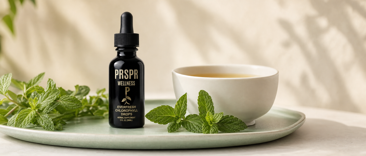 PRSPR Wellness Everfresh Chlorophyll Drops bottle beside fresh peppermint sprigs and a cup of peppermint tea