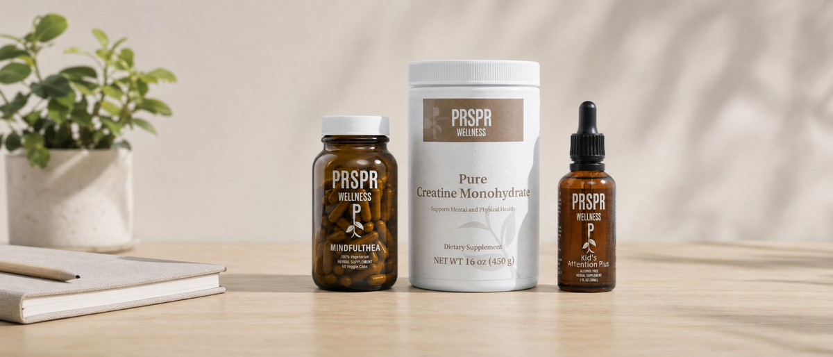 PRSPR Energy & Focus Stack: MindfulThea, Pure Creatine Monohydrate and Attention Plus on a desk beside a notebook and a plant