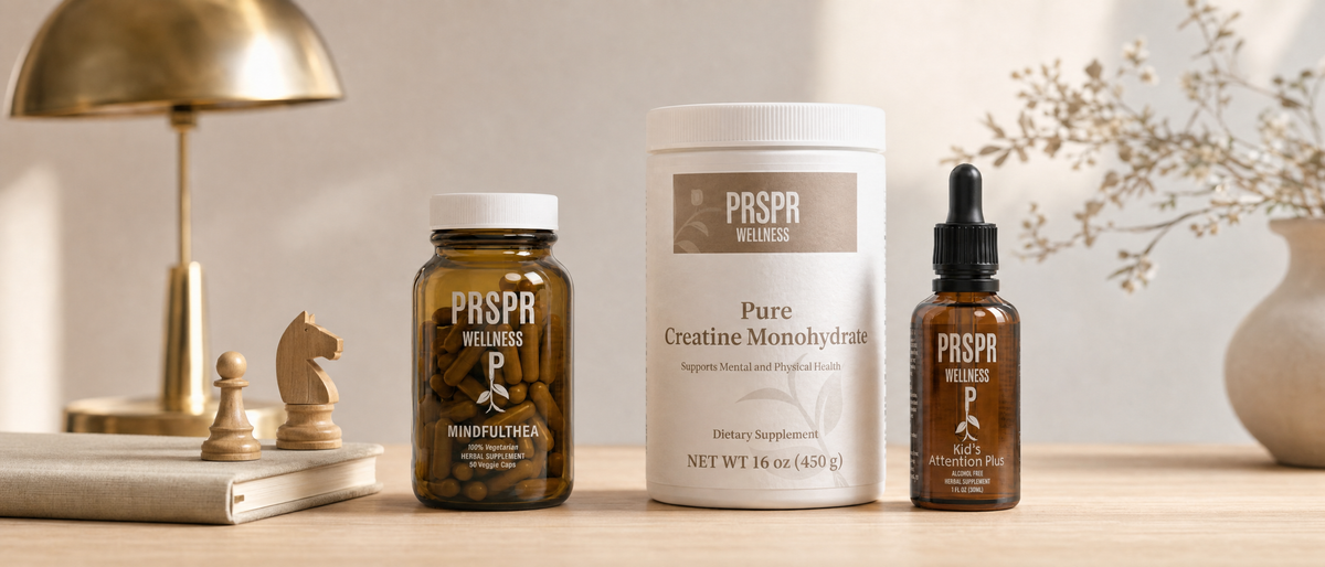 PRSPR Wellness MindfulThea, Pure Creatine Monohydrate and Kid's Attention Plus on a study desk beside chess pieces and a brass desk lamp
