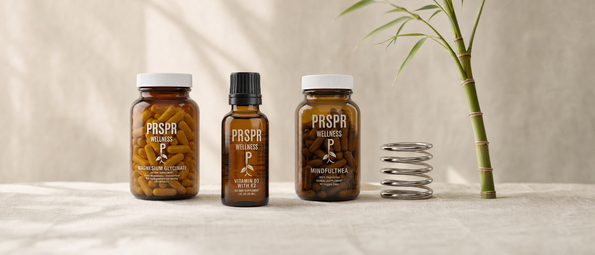 PRSPR Wellness Magnesium Glycinate, Vitamin D3 with K2 and MindfulThea on a linen table beside a steel coil spring and a bending bamboo stalk