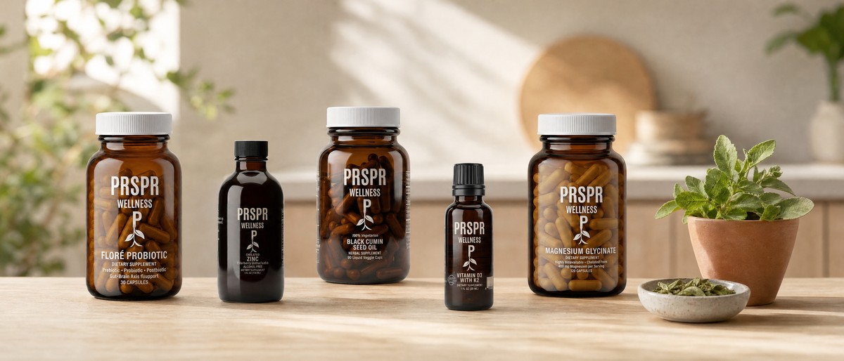 Five PRSPR Wellness supplements from the Women’s Daily Essentials Bundle on a kitchen counter beside a potted stevia plant and dried leaves