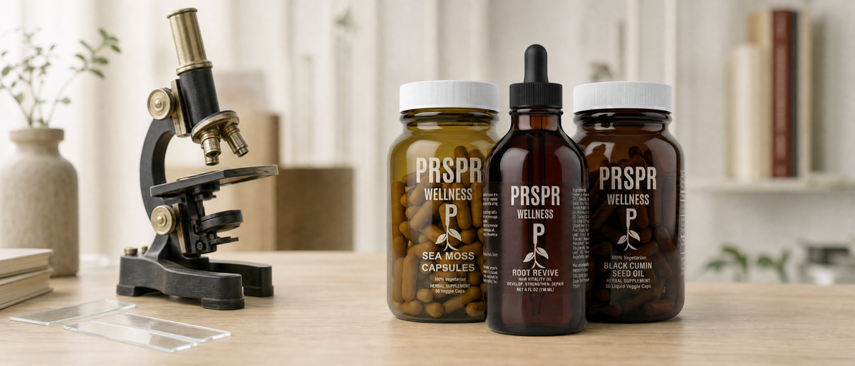 PRSPR Wellness Sea Moss Capsules, Root Revive and Black Cumin Seed Oil bottles on a study desk beside a vintage brass microscope and glass slides.