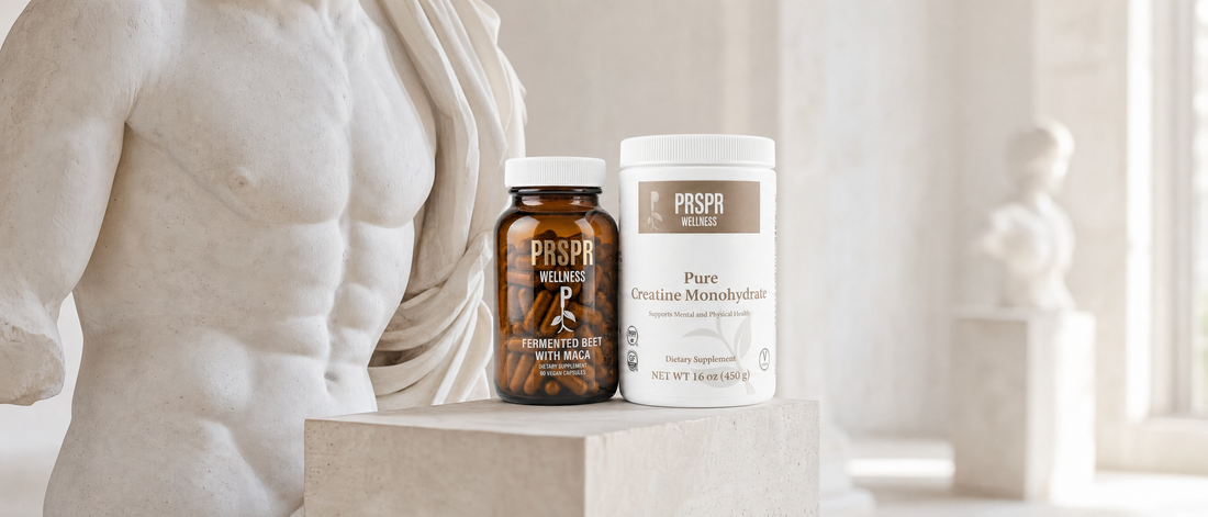 PRSPR Wellness Fermented Beet with Maca and Pure Creatine Monohydrate on a stone plinth beside a classical marble sculpture of an athletic physique.