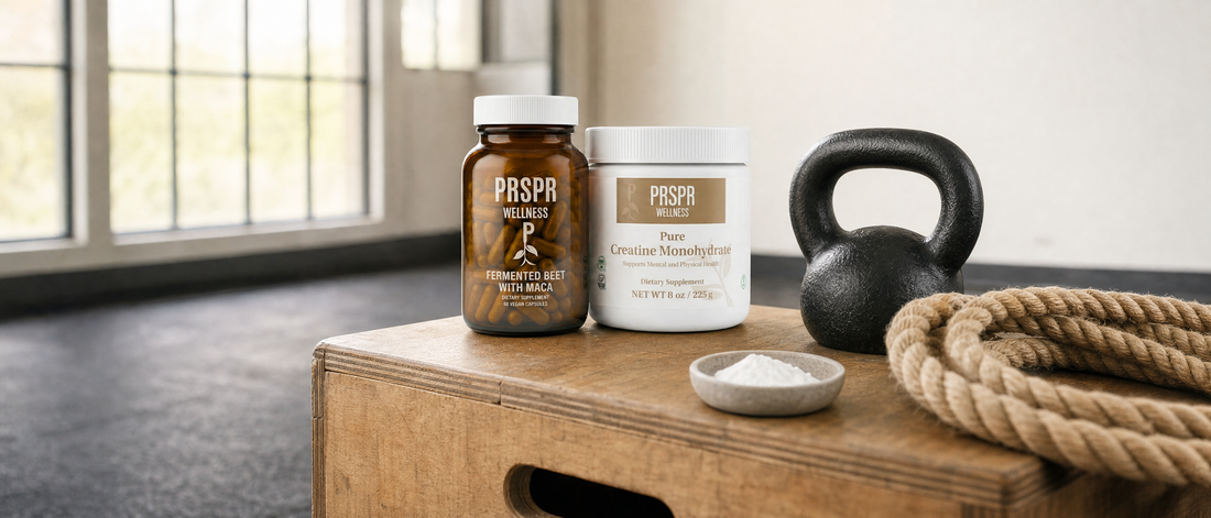 Two PRSPR Wellness containers on a wooden plyo box in a bright training studio beside a black kettlebell, a coiled training rope and a bowl of chalk